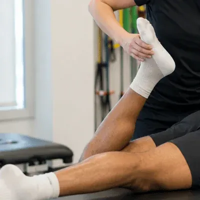 A physical therapist conducts a hamstring strength assessment on an athlete to evaluate readiness for return to sport and track hamstring strain recovery time progress