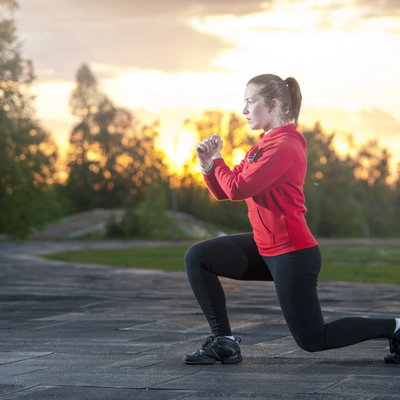 Woman holds lunge at sunset outdoors; functional movement training improves balance, hip strength, and mechanics