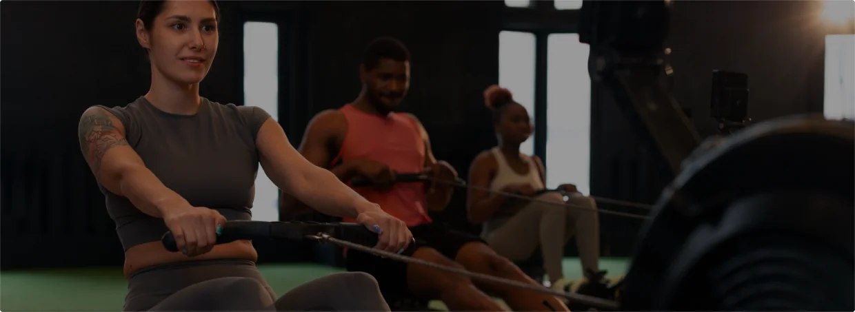 Athletes using rowing machines for cardiovascular conditioning and recovery.